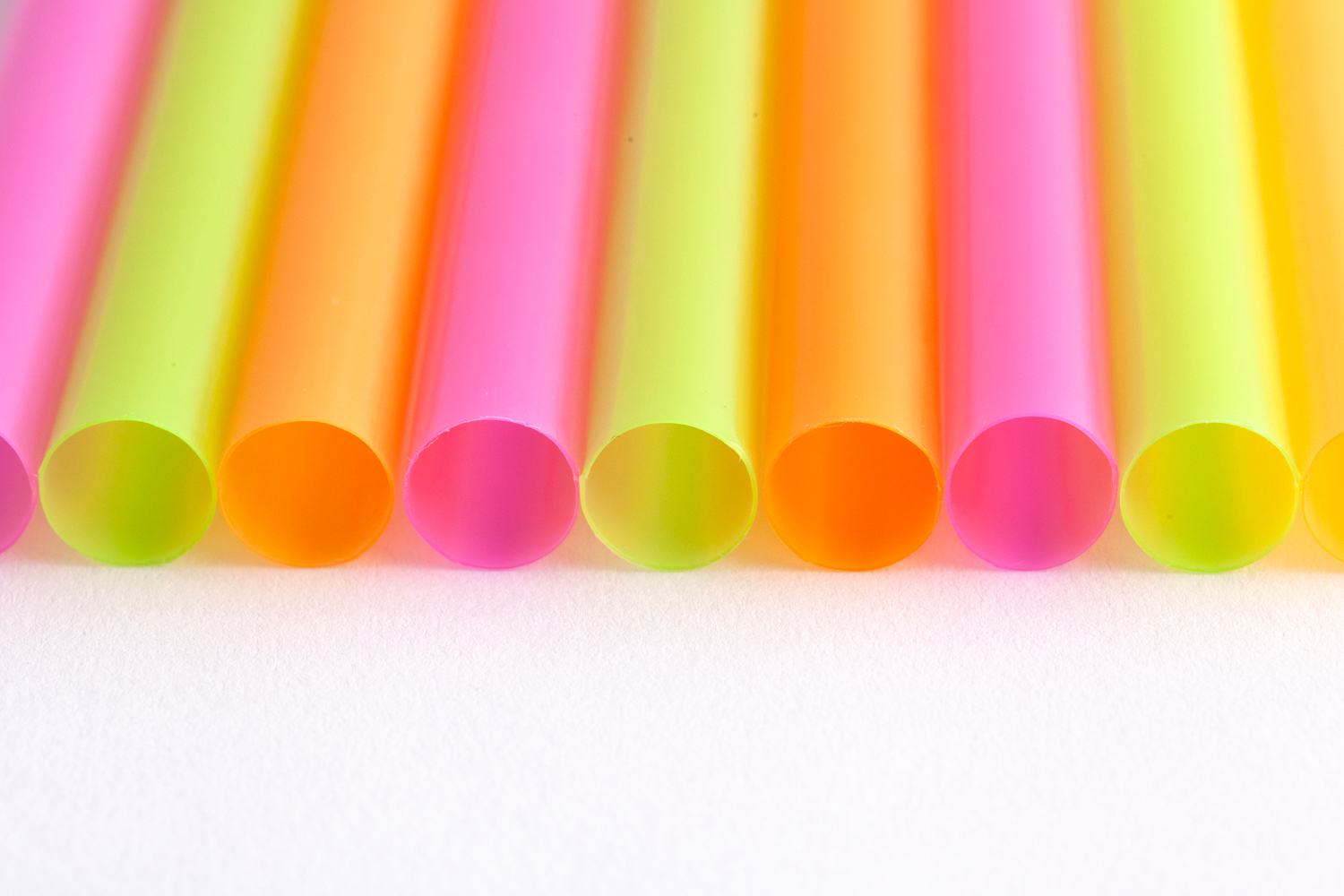 zoomed in on row of multicoloured plastic straws