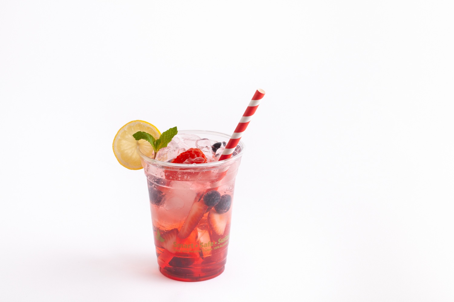 red fruit drink in clear cup with red rainbow straw