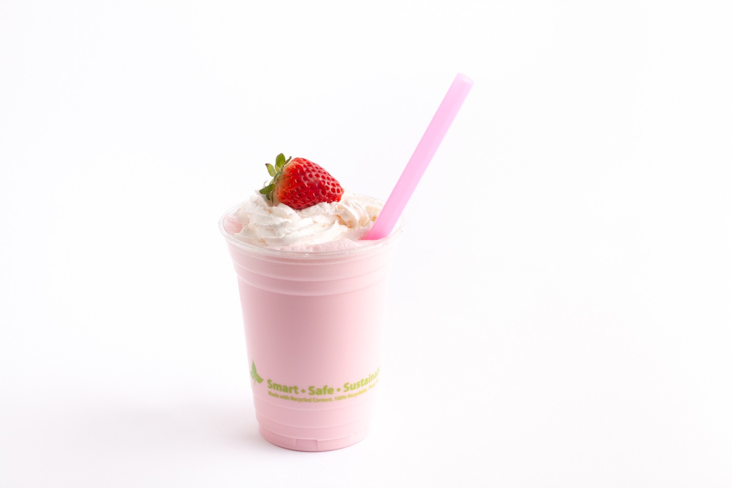 strawberry milkshake in clear cup with large specialty straw