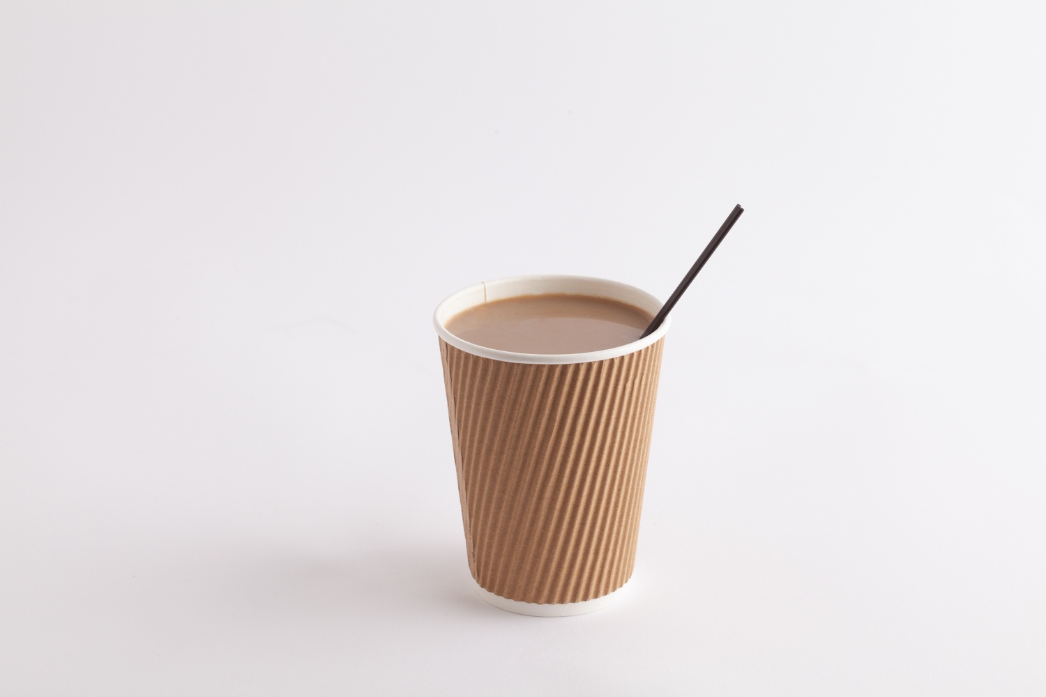 paper coffee cup with coffee and coffee stirrer