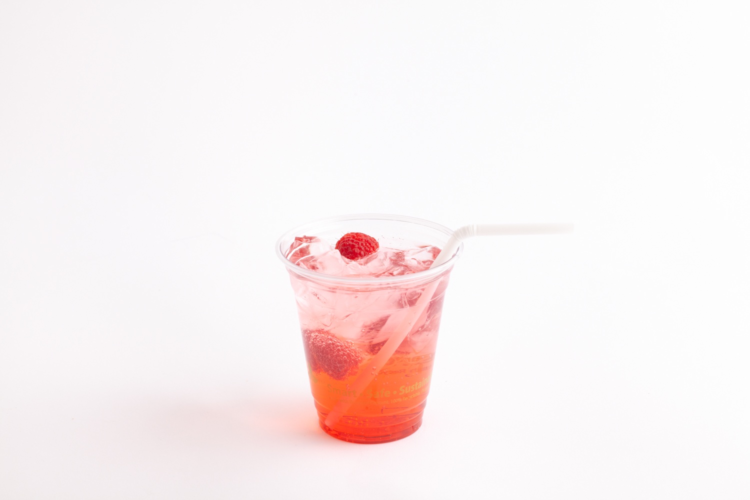 red fizzy drink in clear cup with flex straw