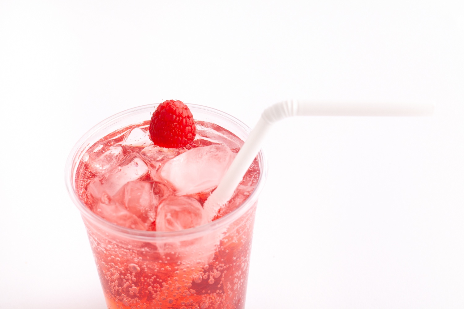 red fizzy drink in clear cup with flex straw