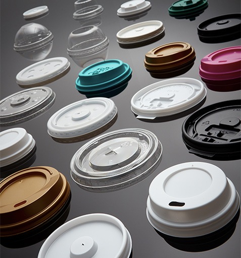 stock image of hot cup lids laid out on table