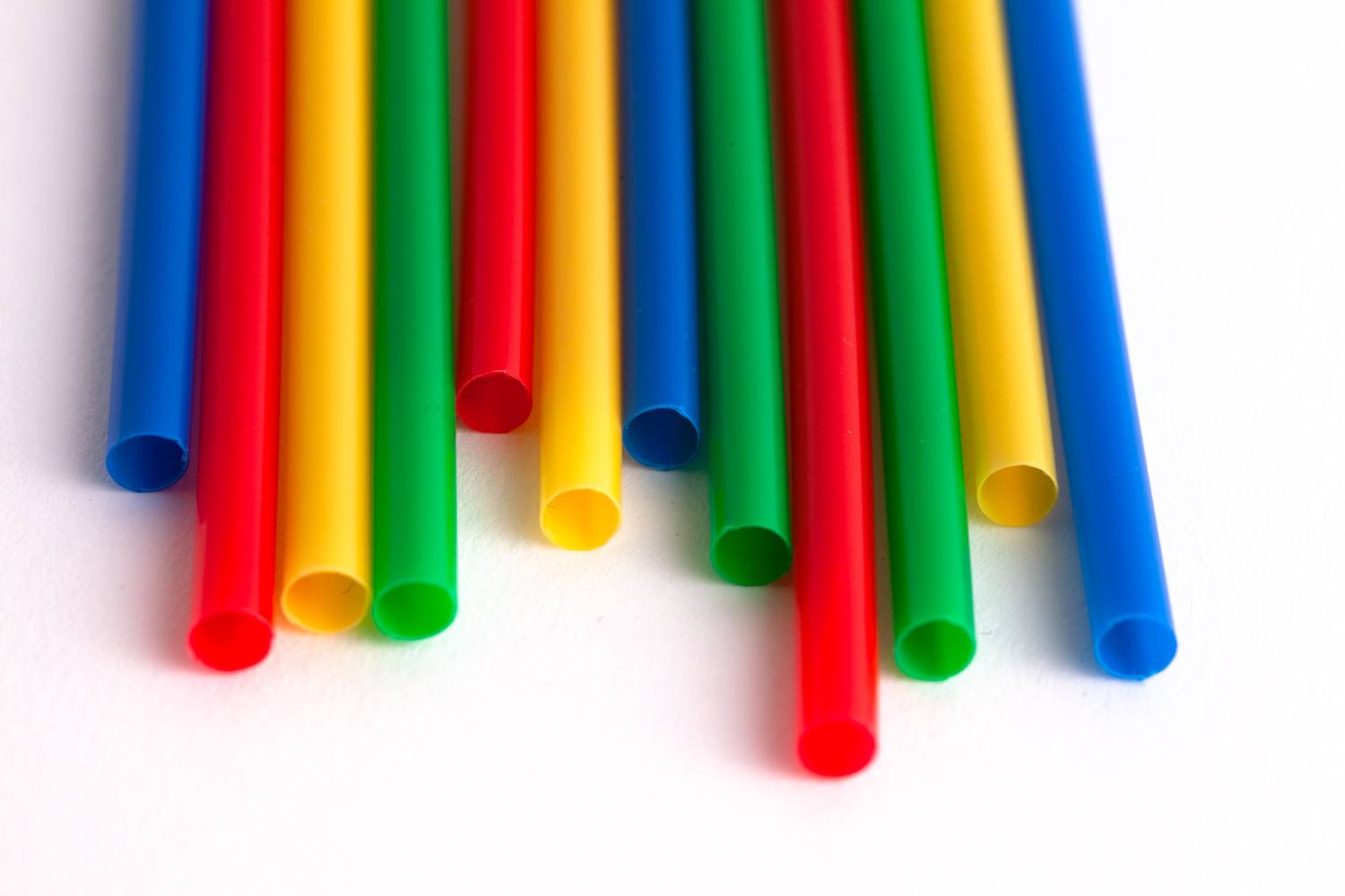 rainbow cocktail straws lined up in a row