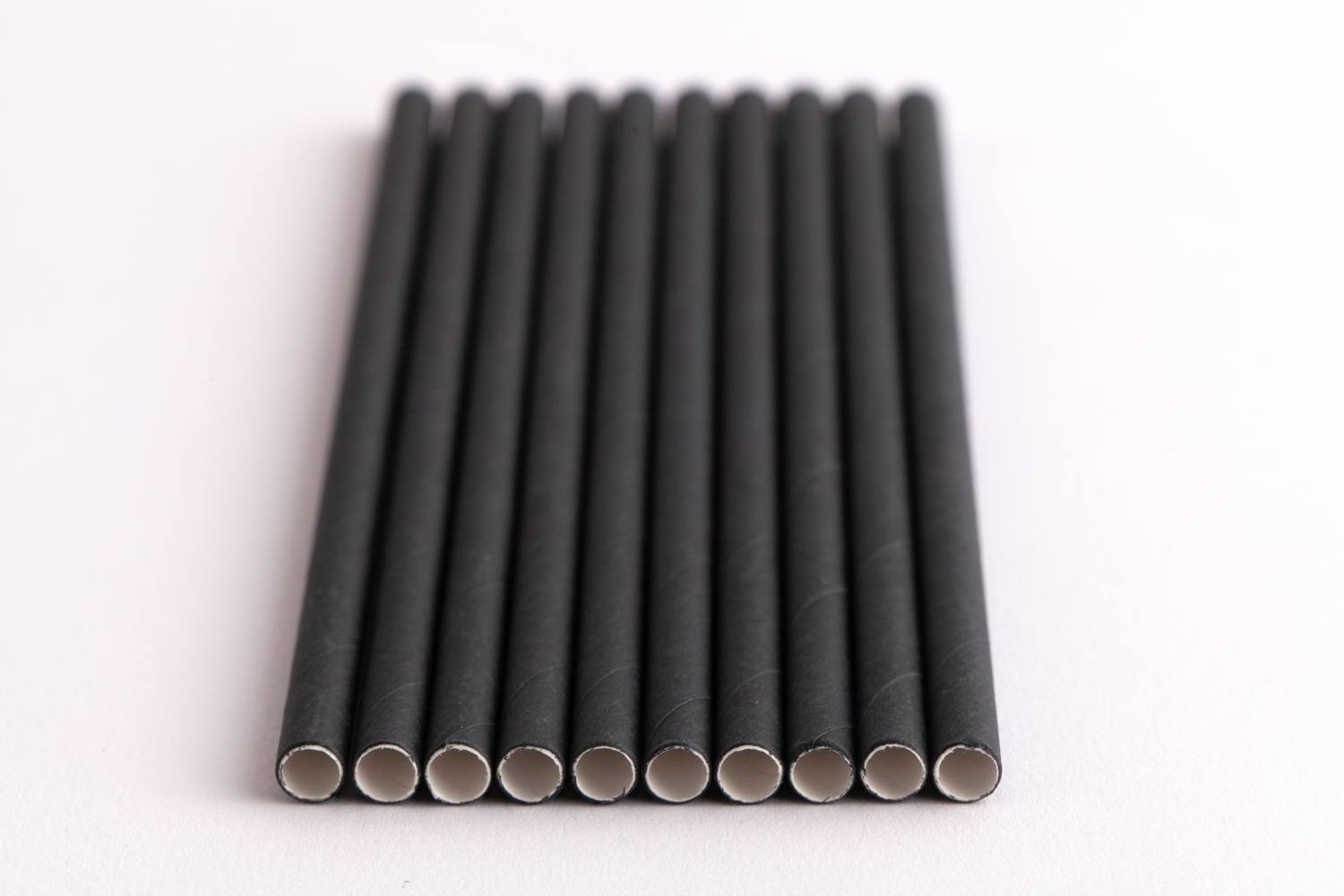 black paper straws lined up in a row