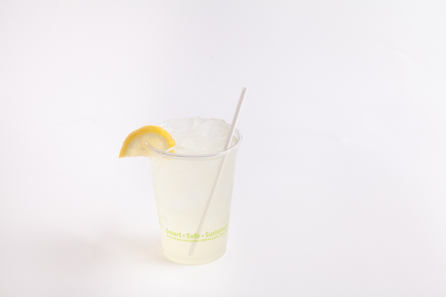 clear drinking cup filled with lemonade with back to earth straw