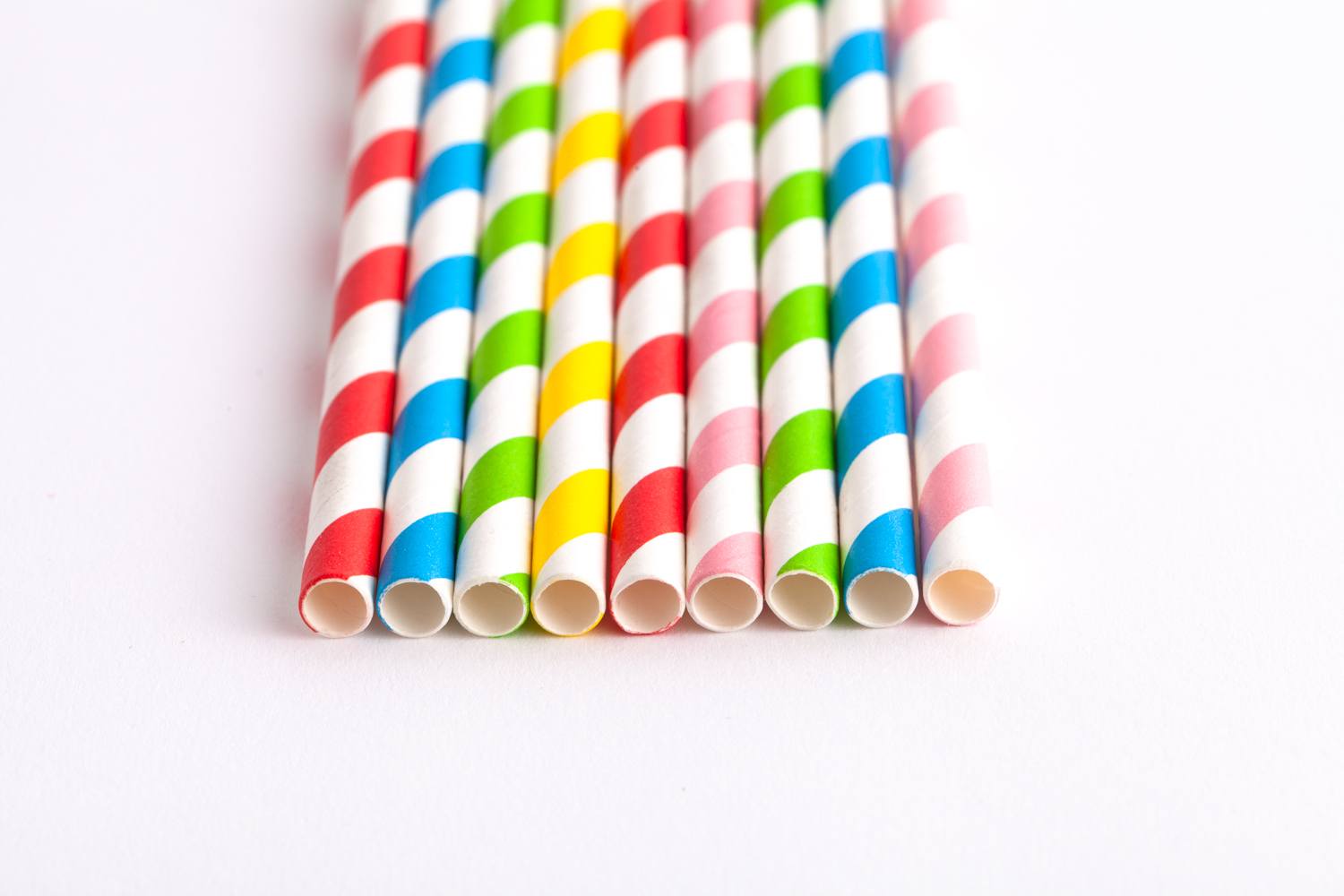multi-coloured paper straws lined up in a row